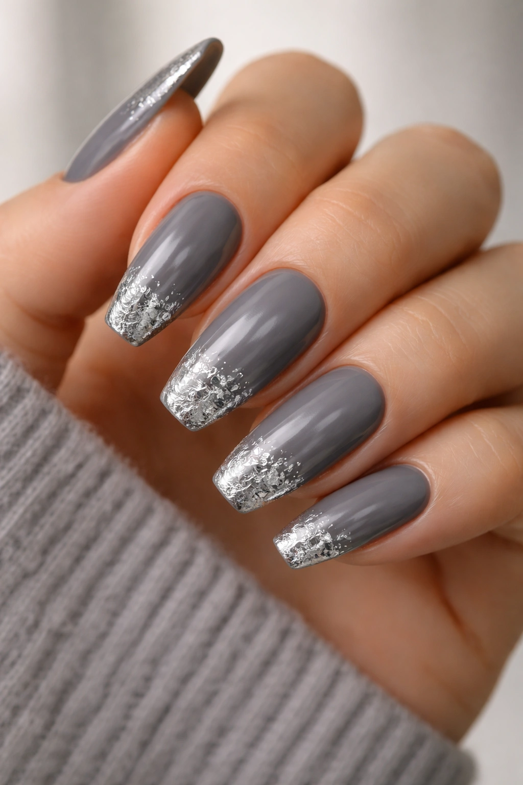Pewter nails with small silver foil fragments near the tips