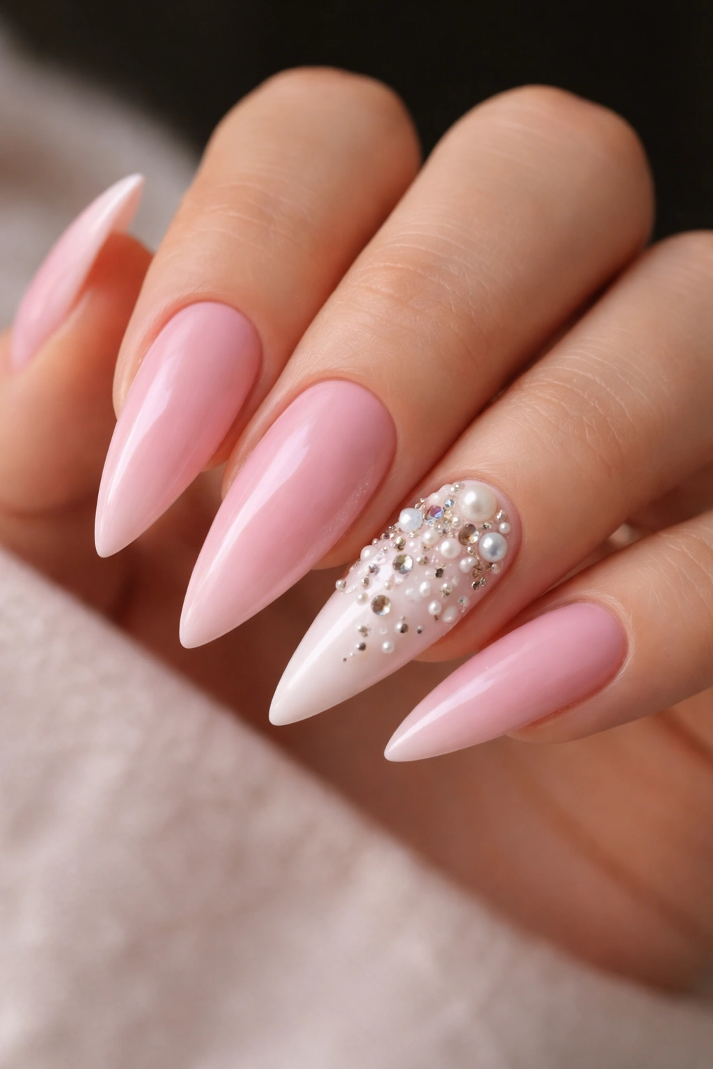Pink nails with white 3D embellished accent nail on stiletto shape