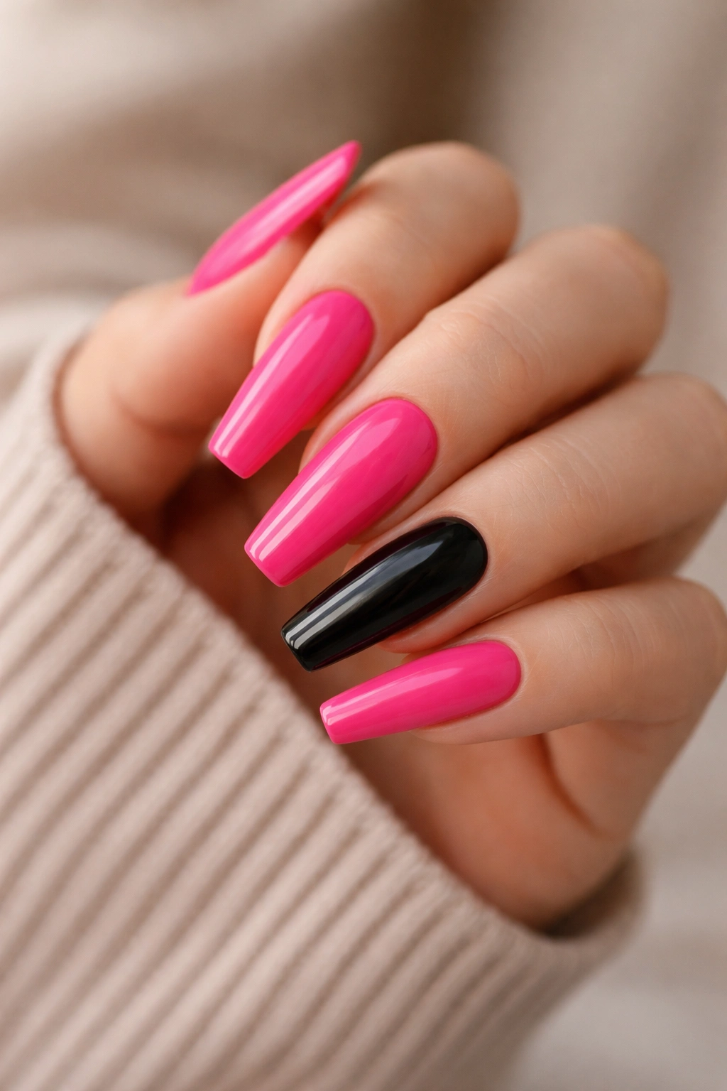 Coffin nails showing pink nails with a single black accent nail