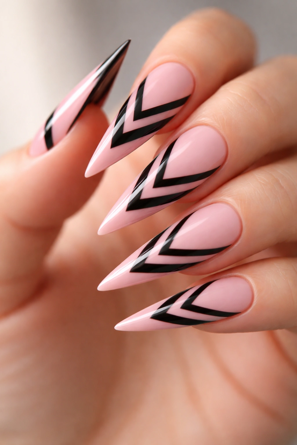 Pink stiletto nails with black striped chevron details