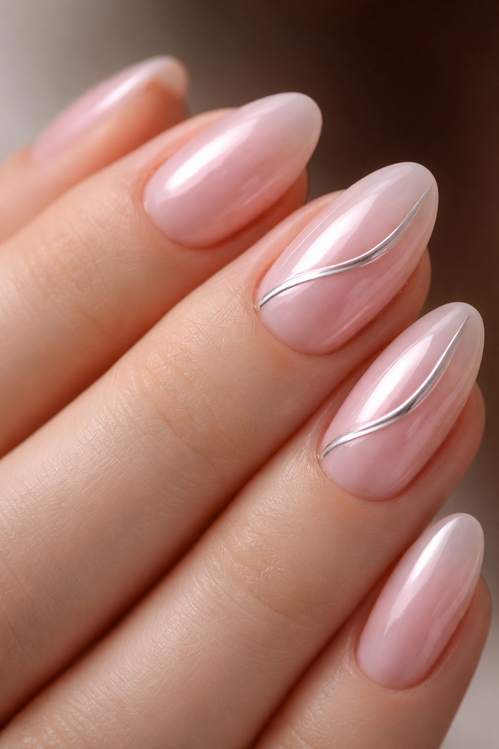 Close-up of pink chrome swirl detail on almond nails
