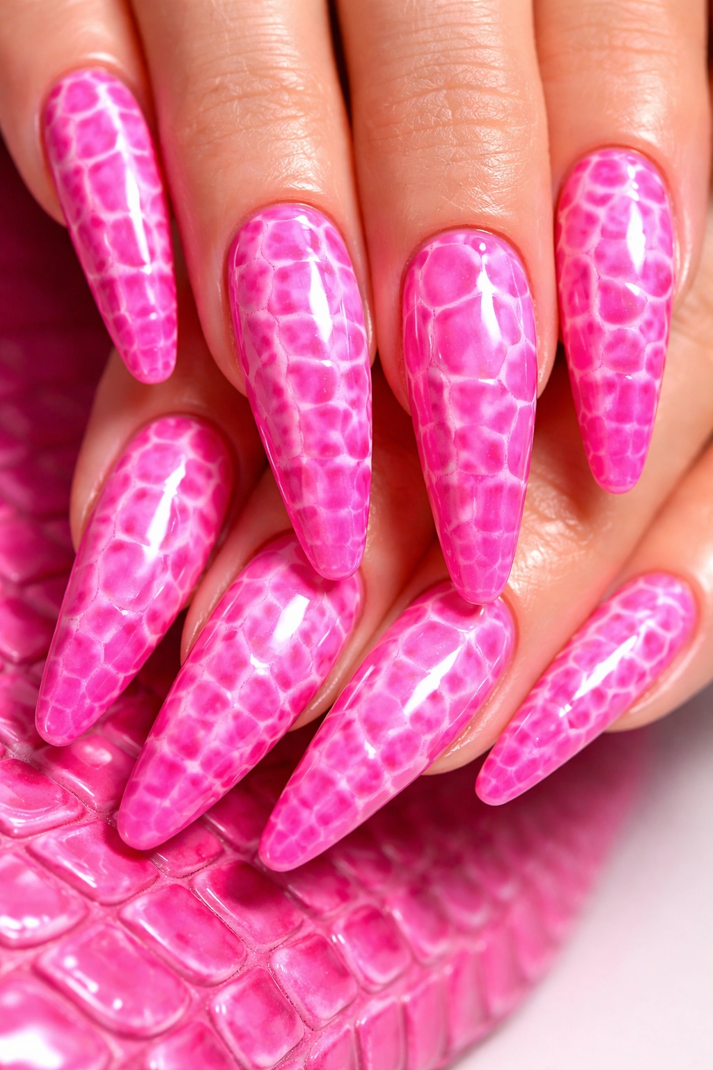 Hot pink crocodile texture nails with light-scale accents in a glossy finish