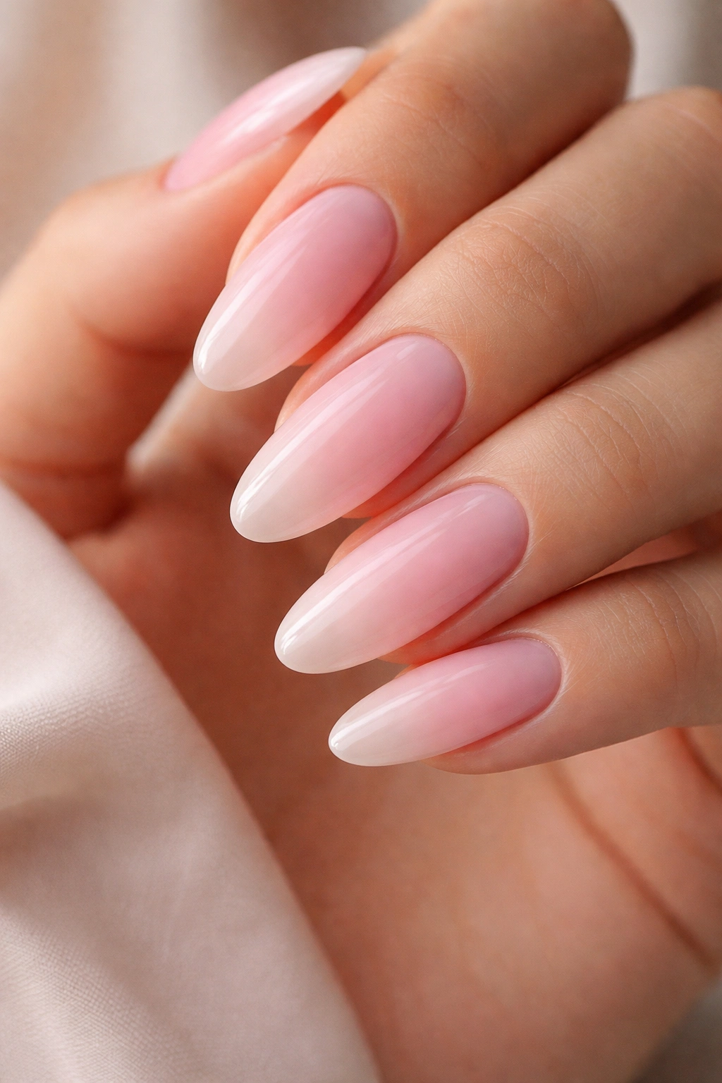 Long oval nails with pink-to-nude fade on almond-shaped edges