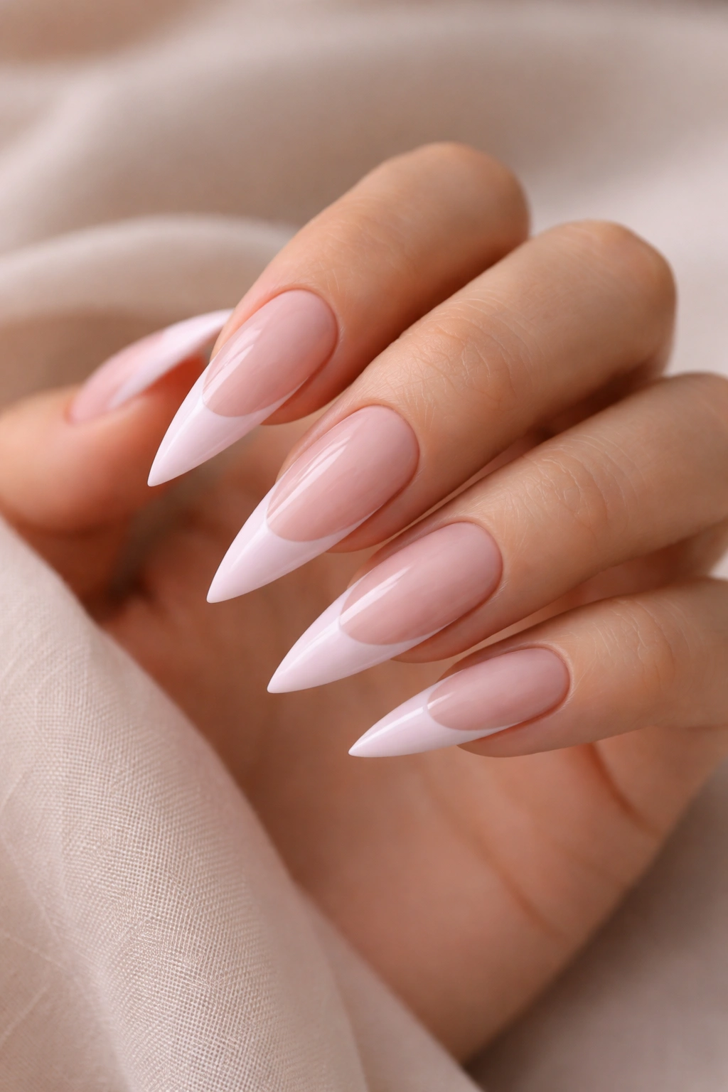 Close-up of finished light pink French tip stiletto nail design