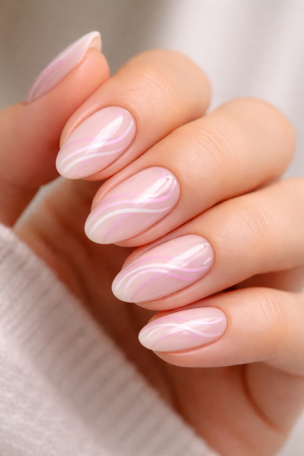Pink and lilac swirl nails on almond nails