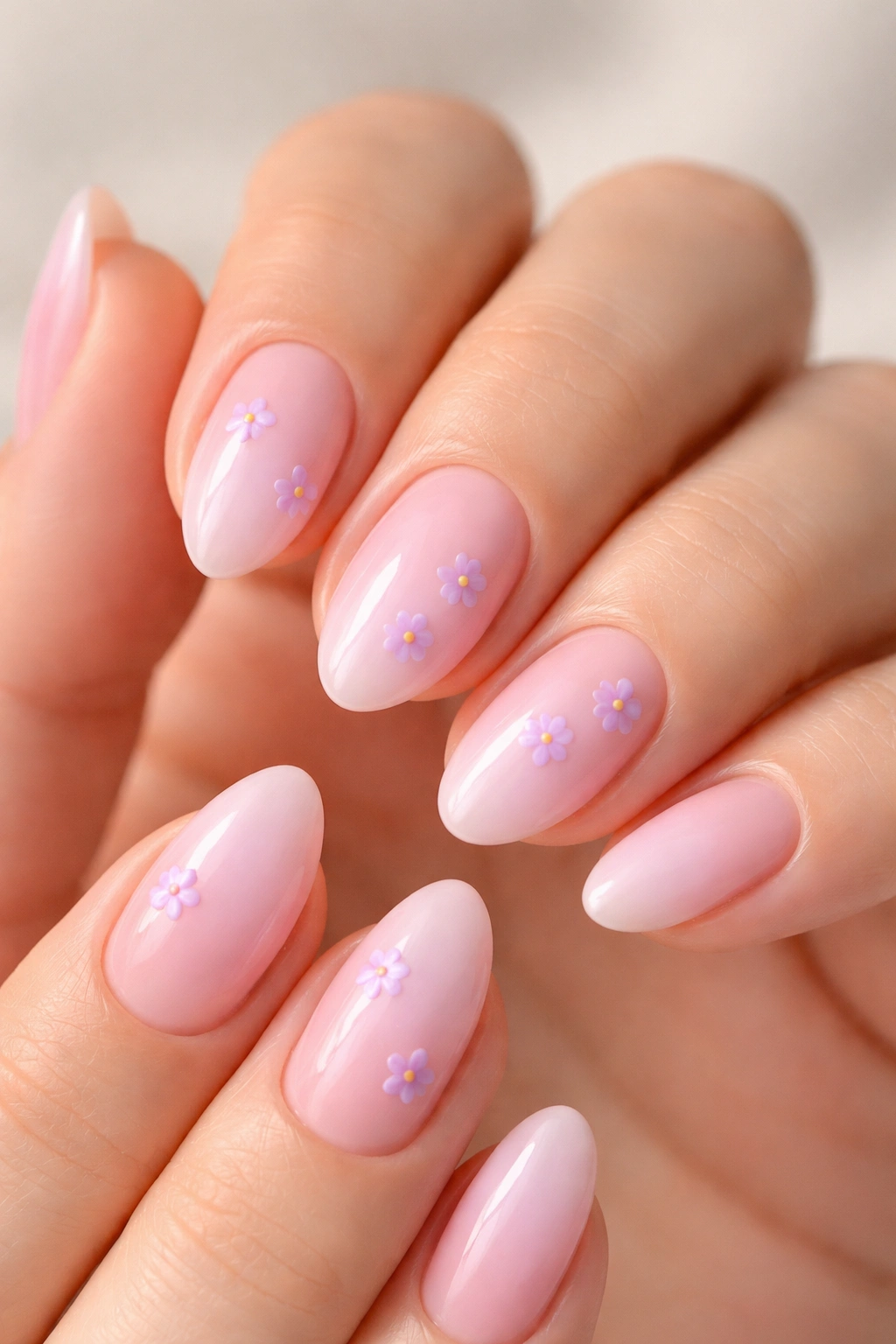 Pink ombre nails with tiny lilac flowers on two nails