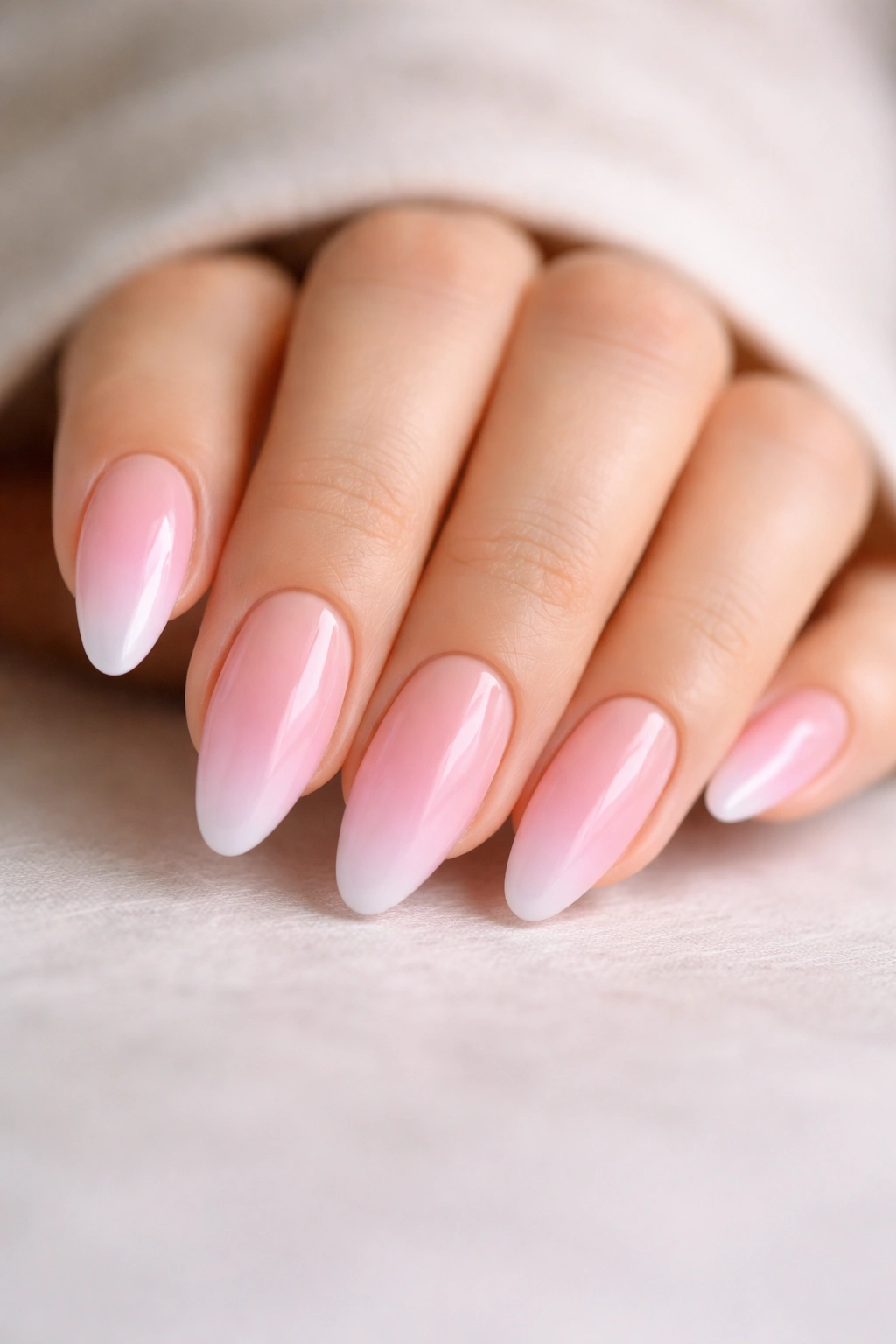 Almond nails with pink gradient fade from base to tip
