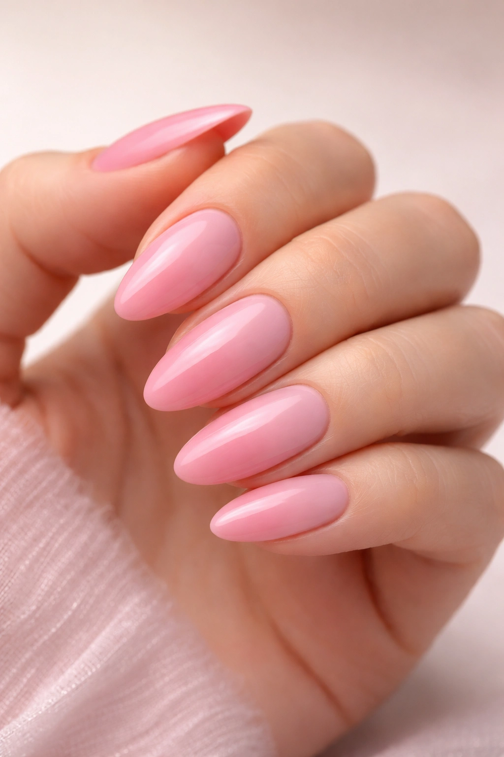 Hand with pink ombre nails showing a seamless gradient