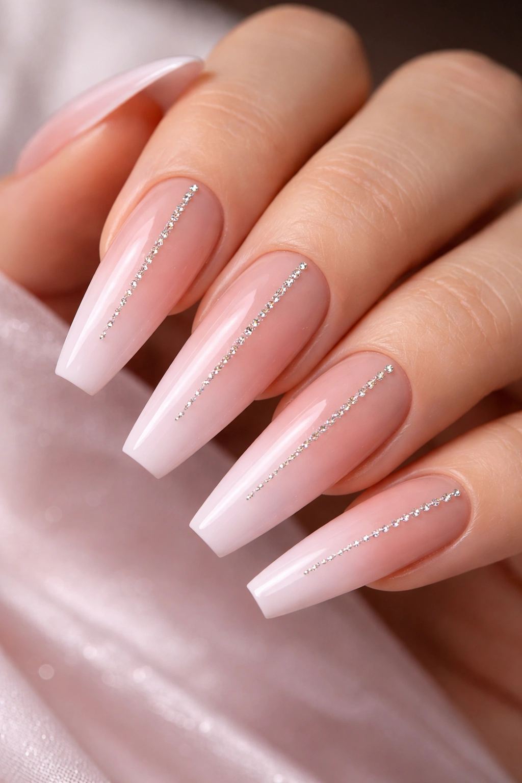 Coffin nails with soft pink ombre and rhinestone line
