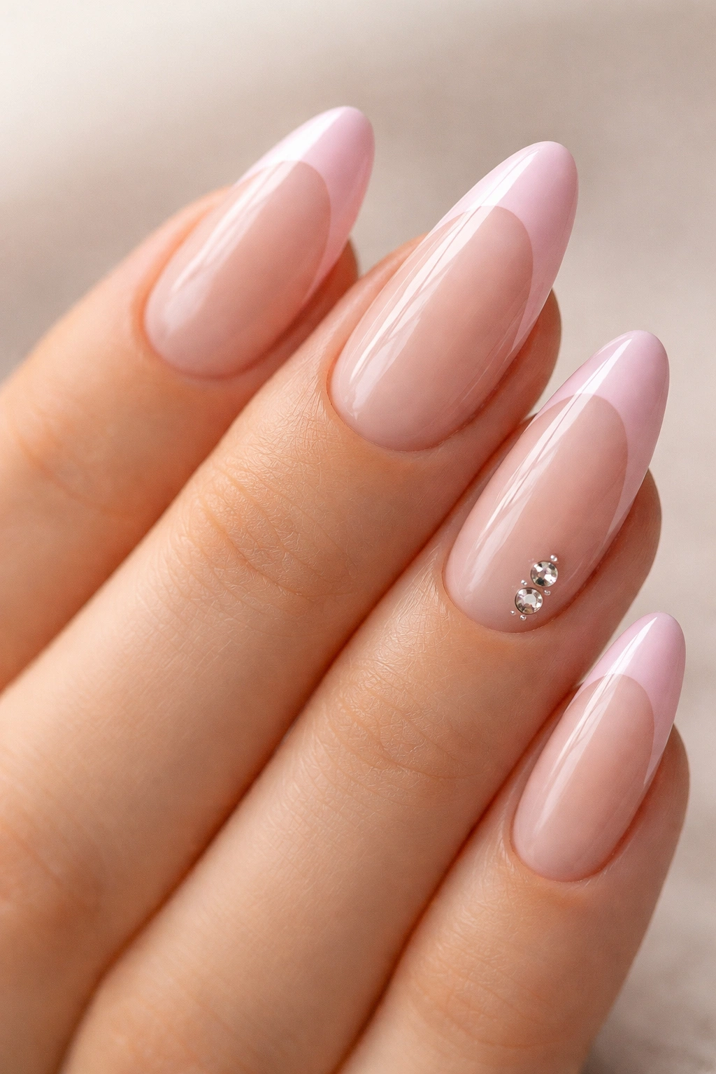 Almond nails with pink tips and small rhinestones