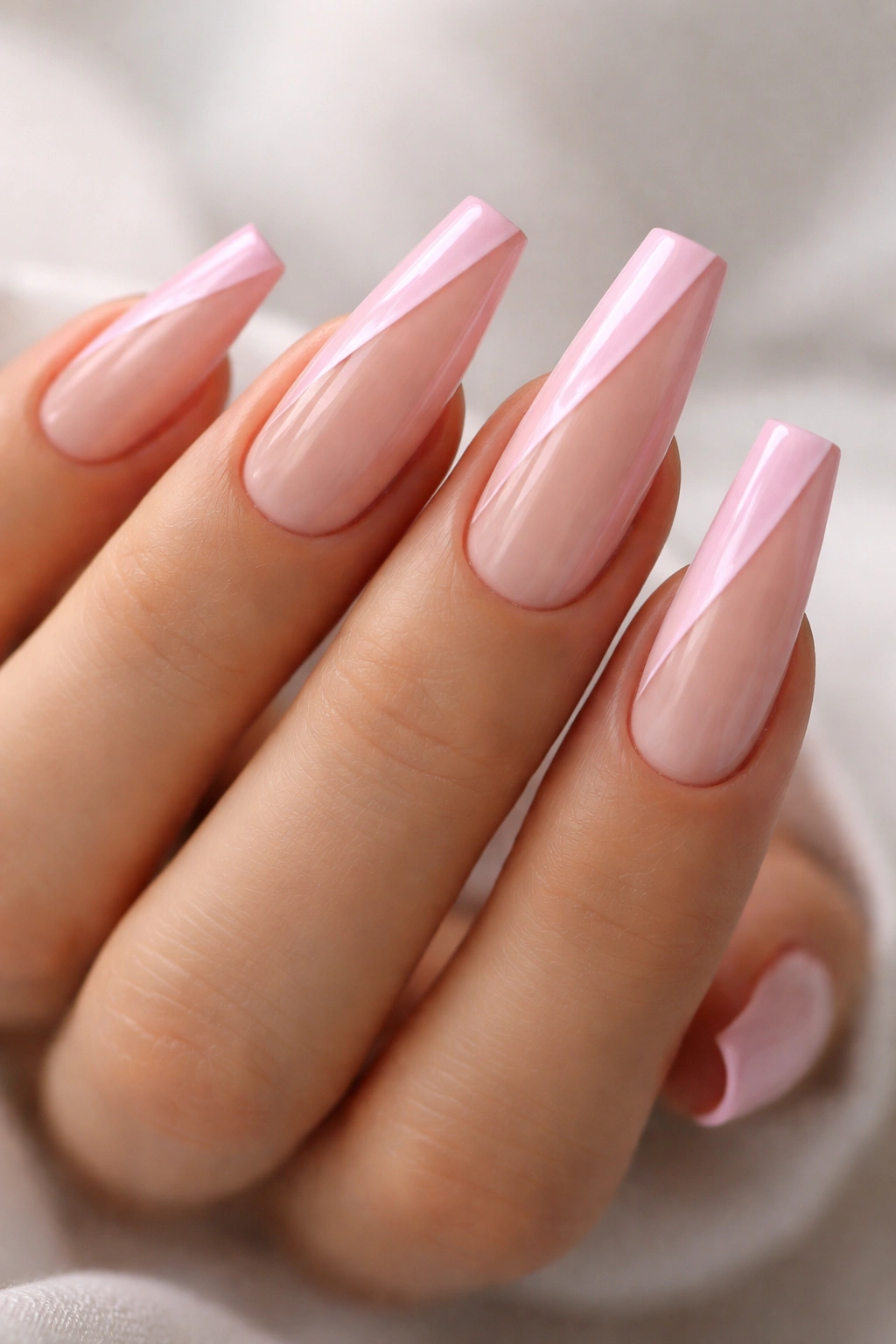 Close-up of pink side-French nails on ballerina nails with curved side band and sheer rest