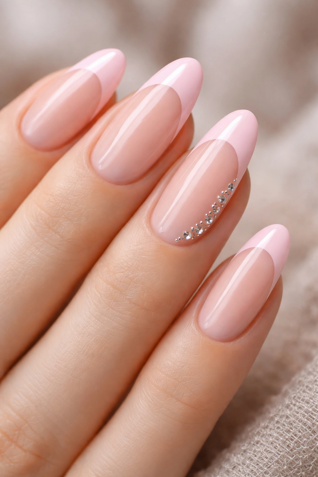 Long oval nails with pink tips and a small rhinestone trail