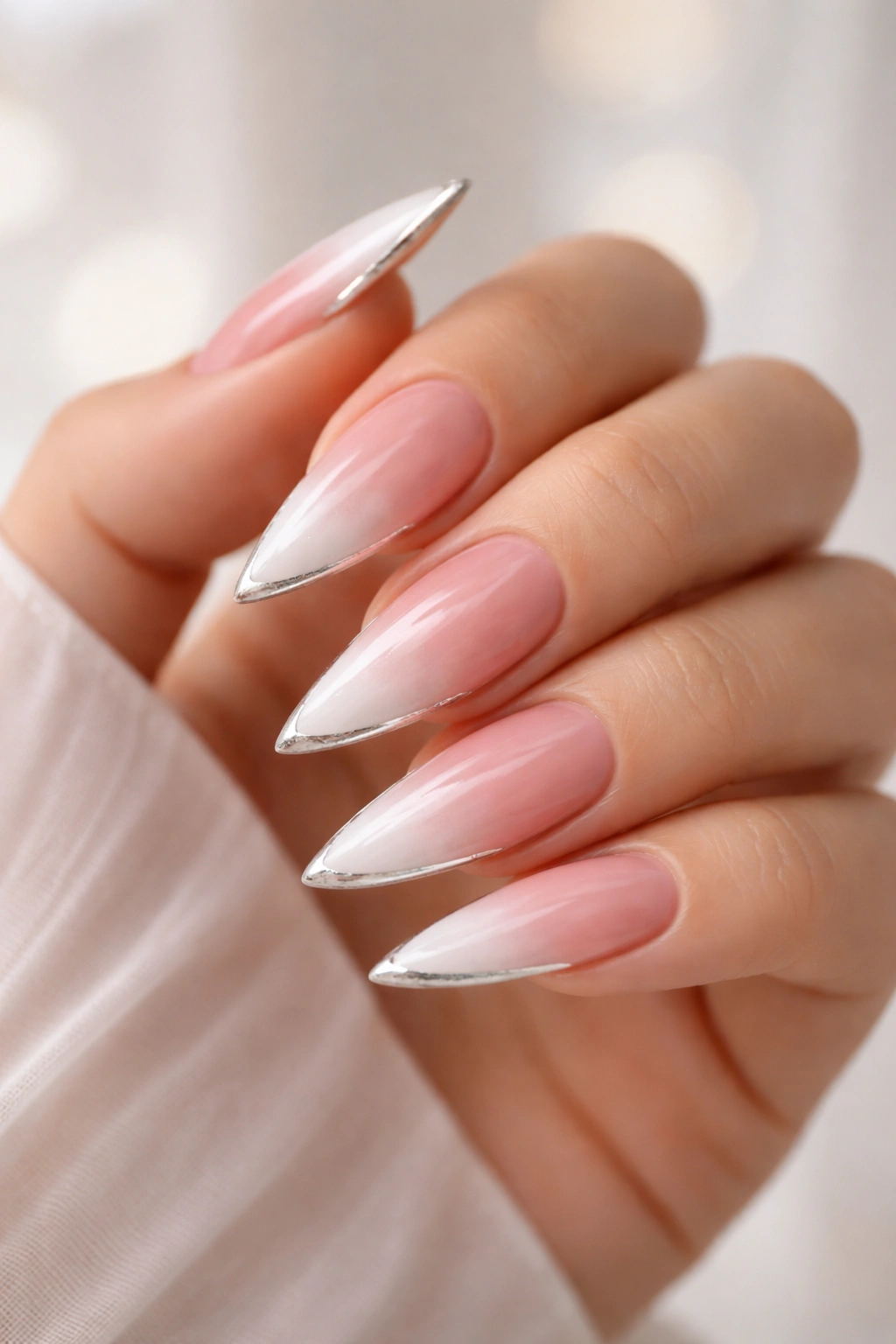 Ombre pink to white nails with a metallic edge on the tip