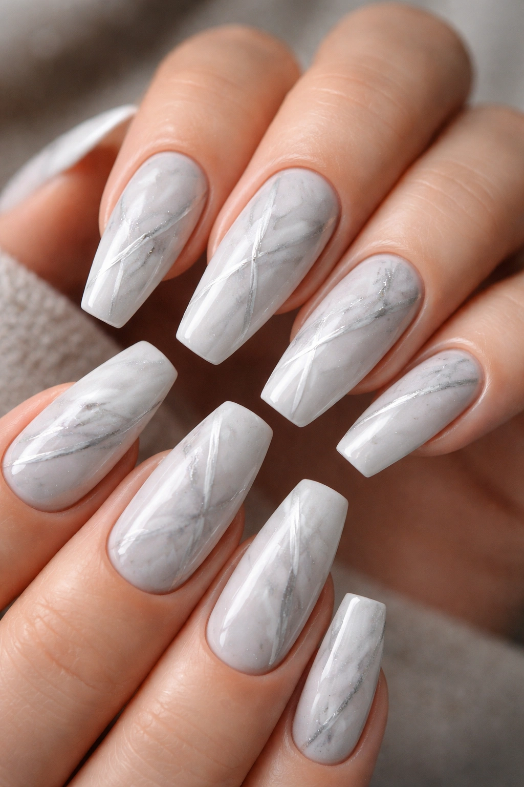 Close up of platinum marble nails with fine white veining