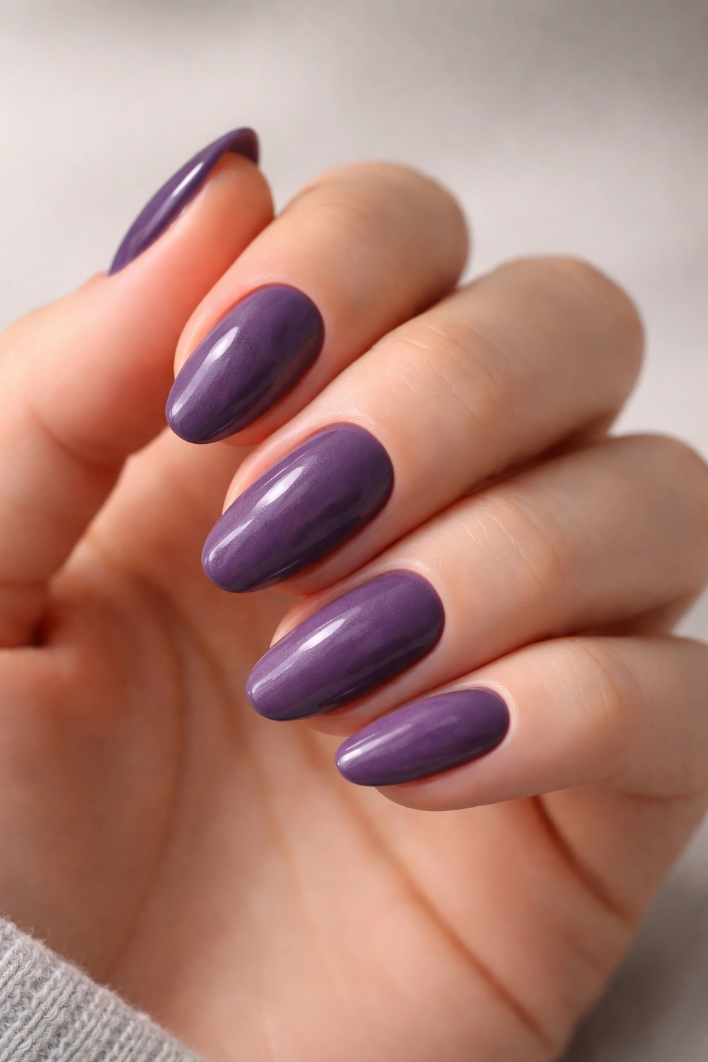 Cool-toned plum nails on hand illustrating undertone considerations