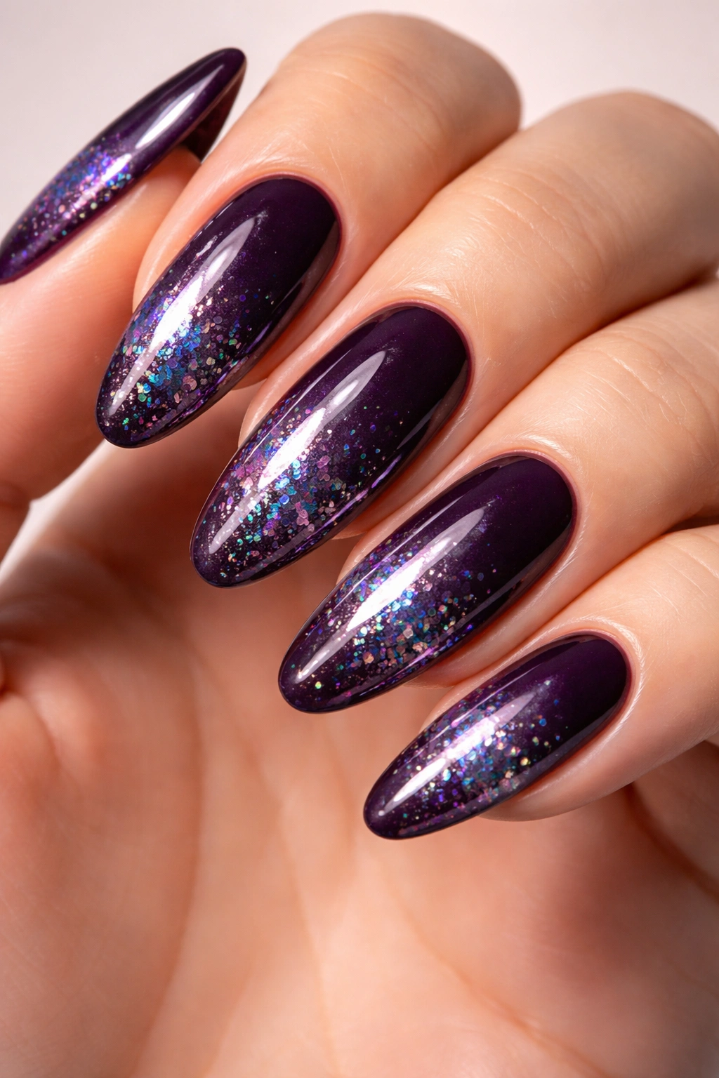 Plum nails with holographic accents on long ovals