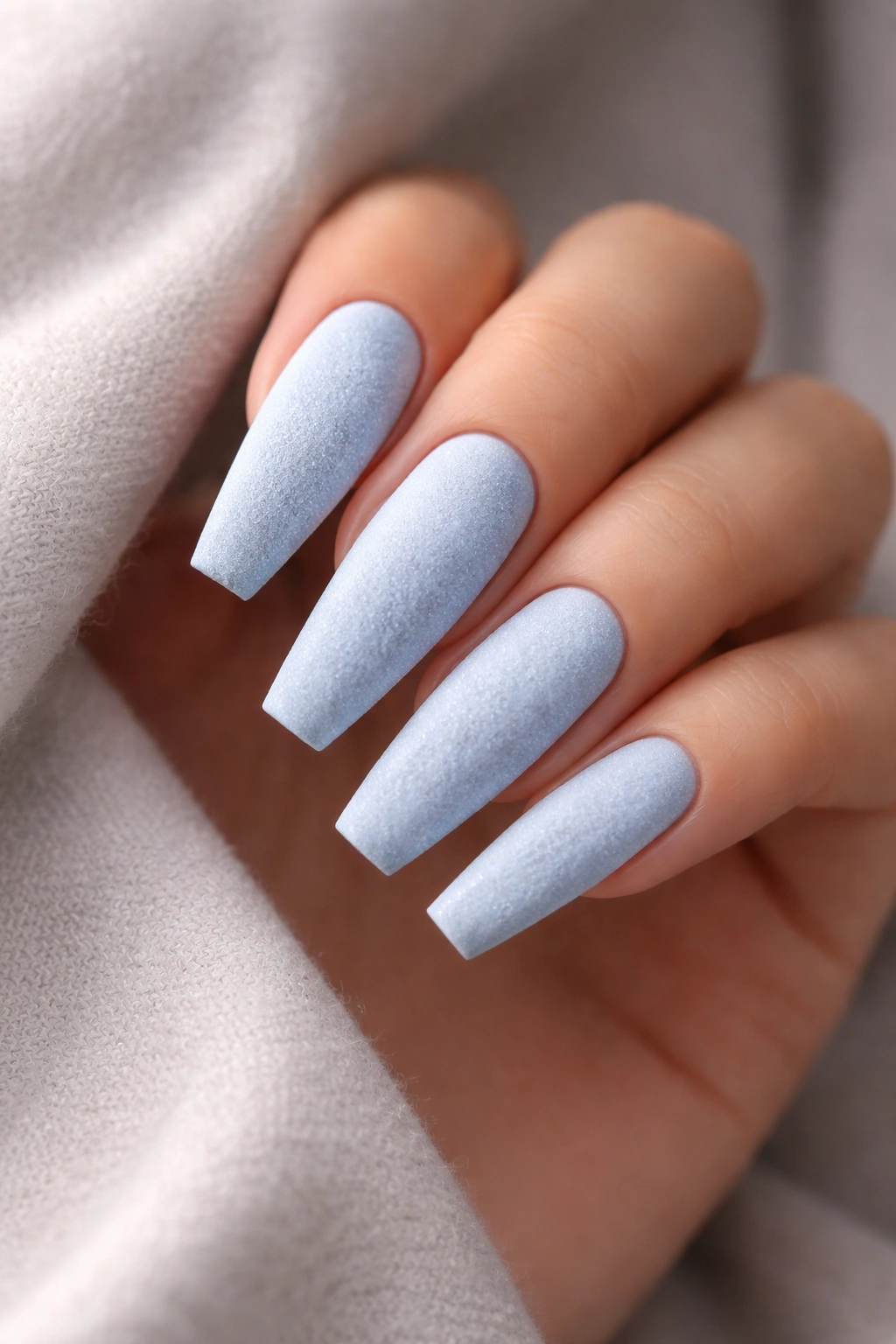 Powder blue velvet nails on long coffin shape with matte textured finish