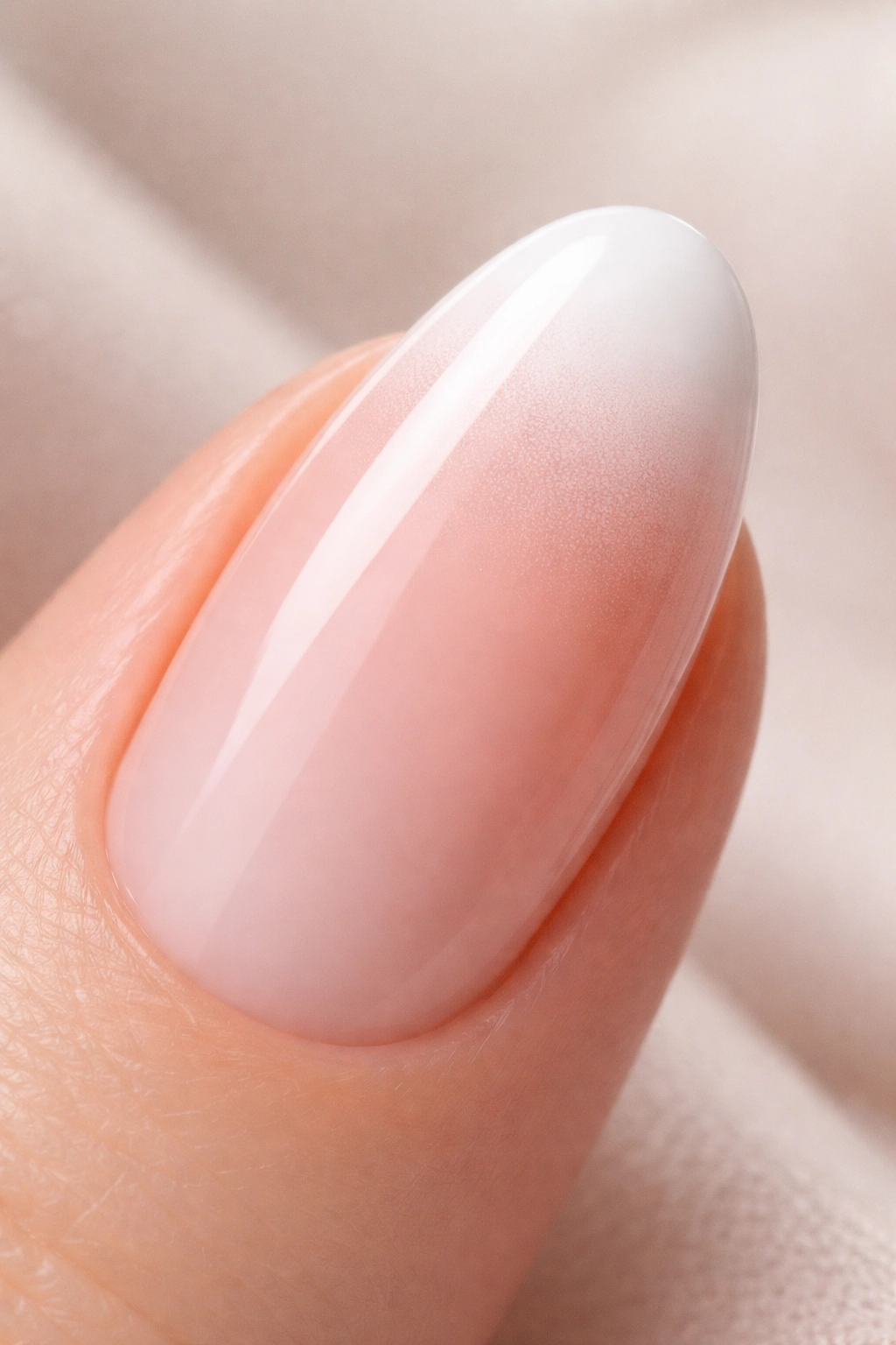Close-up of an oval nail with powder gradient tip