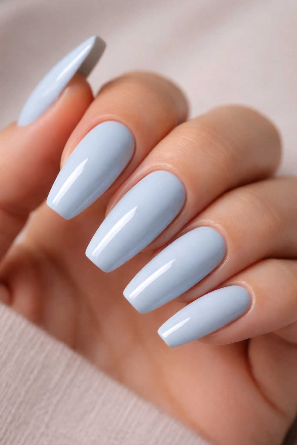 Powdery baby blue ballerina nails with glossy finish