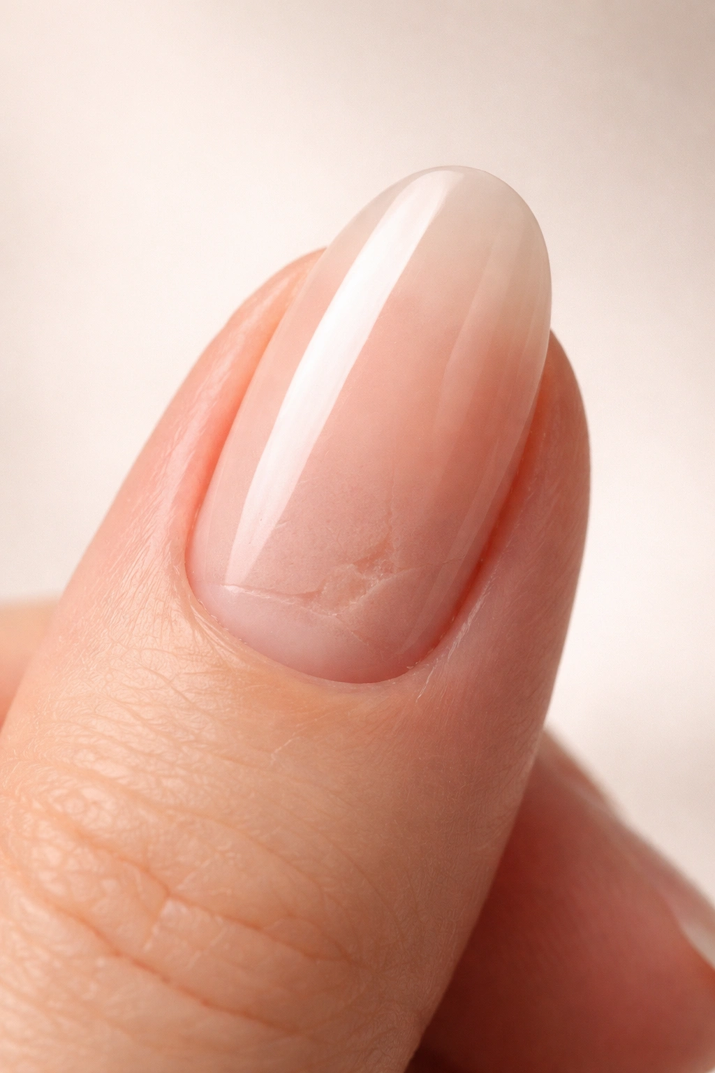 Close-up of finger with a press-on nail concealing damaged natural nail