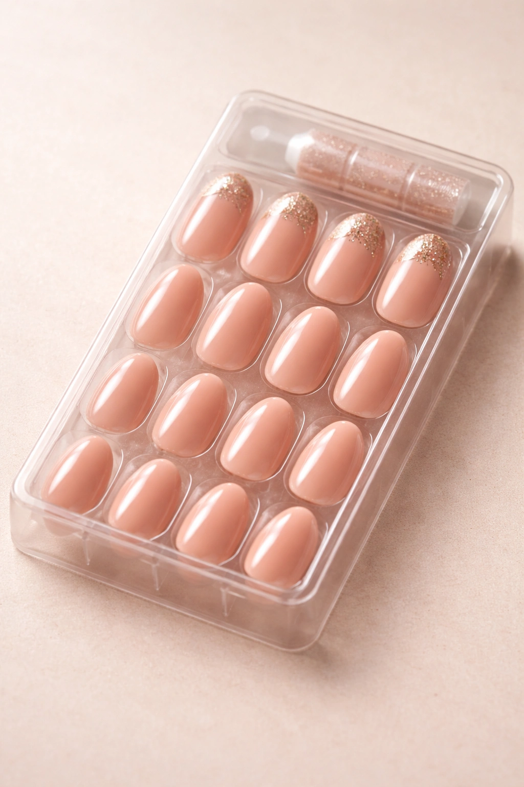 Glossy press-on nails laid out on a neutral background