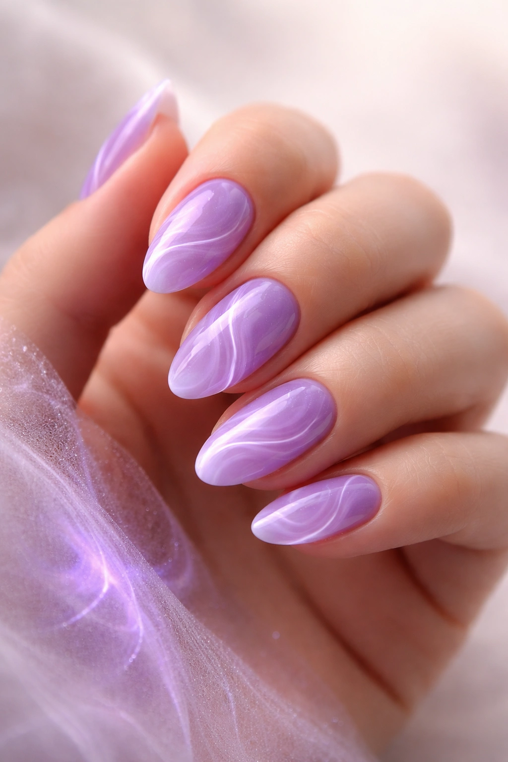 Close-up of short almond nails with purple aura swirls