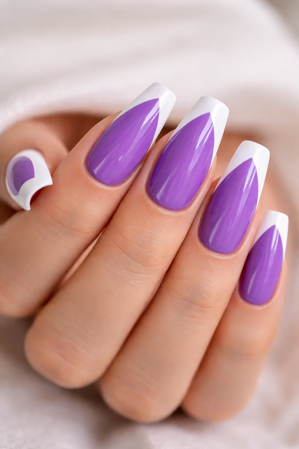 Vibrant purple coffin nails with white chevron tips
