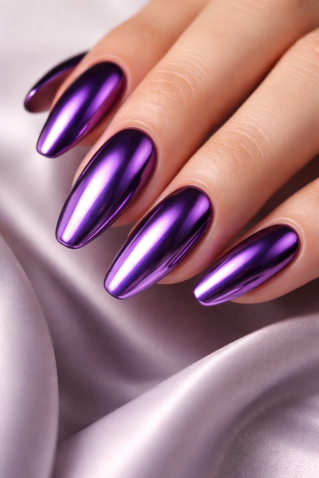 Close-up of purple chrome nails showing deep plum to lavender shimmer with mirror finish