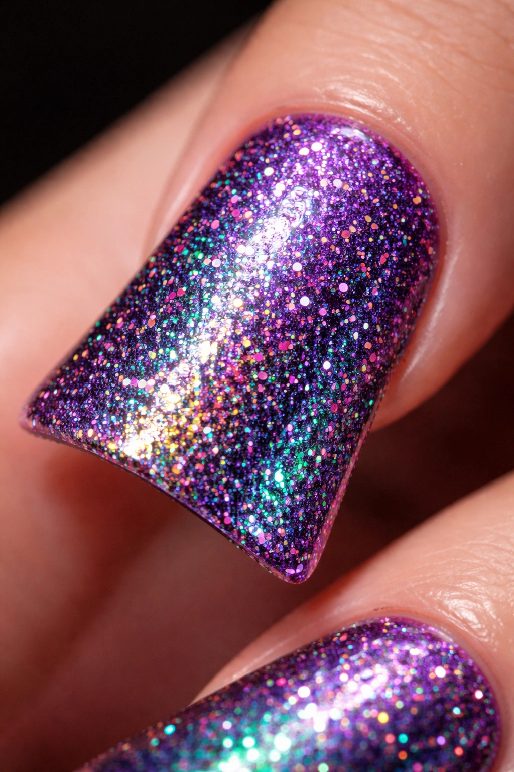 Duck nail with deep purple base and holographic glitter shifts.