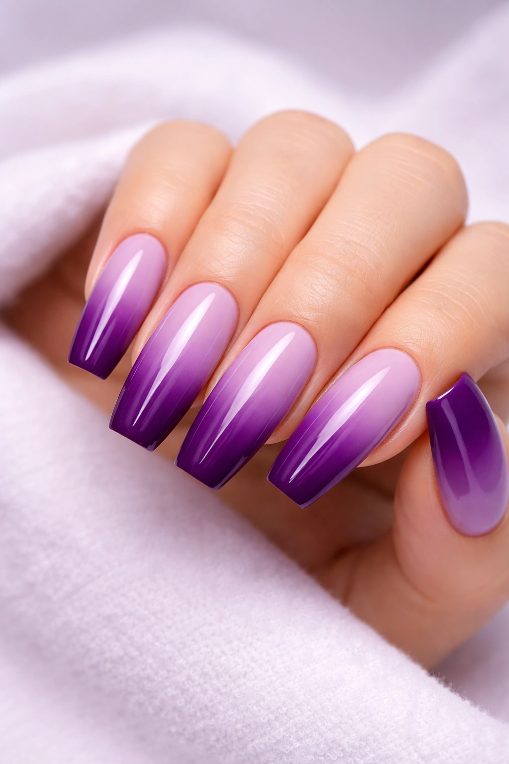 Two-tone purple gradient nails from lavender to plum