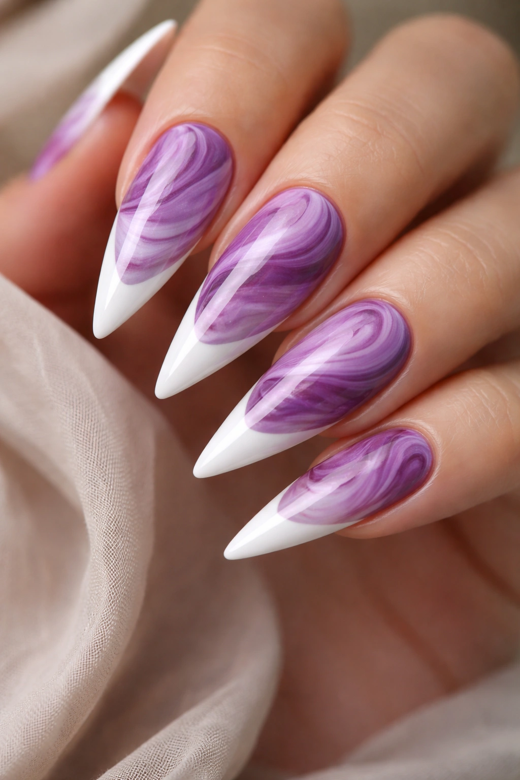 Purple marble swirl nails with white French tips on stiletto shape