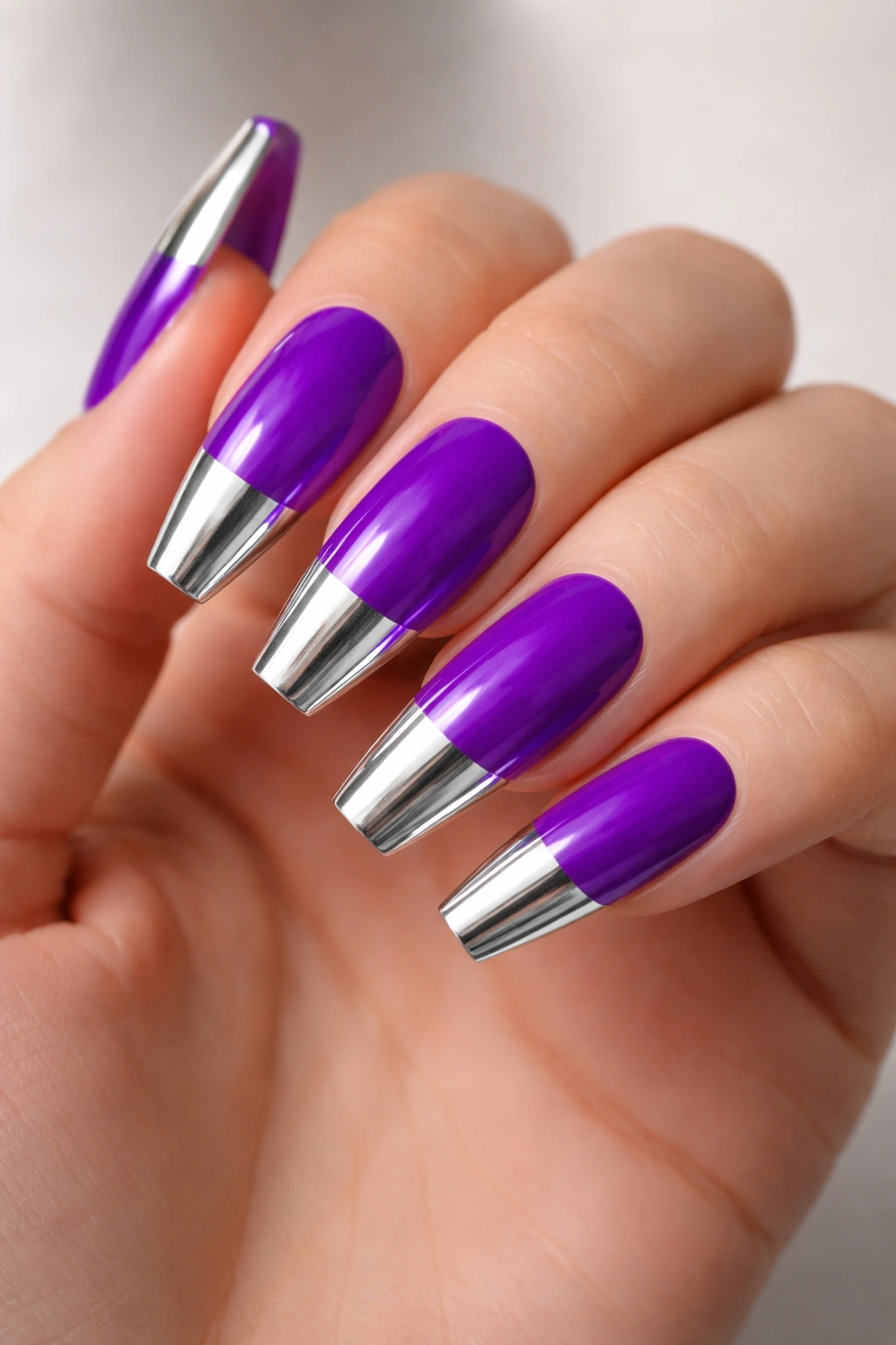 Coffin nails in electric purple with silver chrome tips.