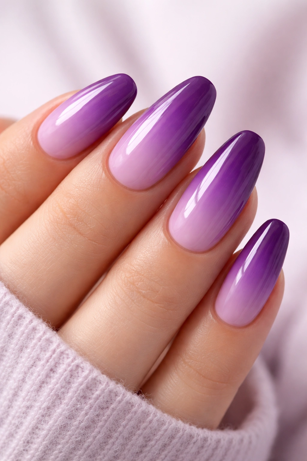 Close-up of purple ombre nails from lavender to plum with glossy finish