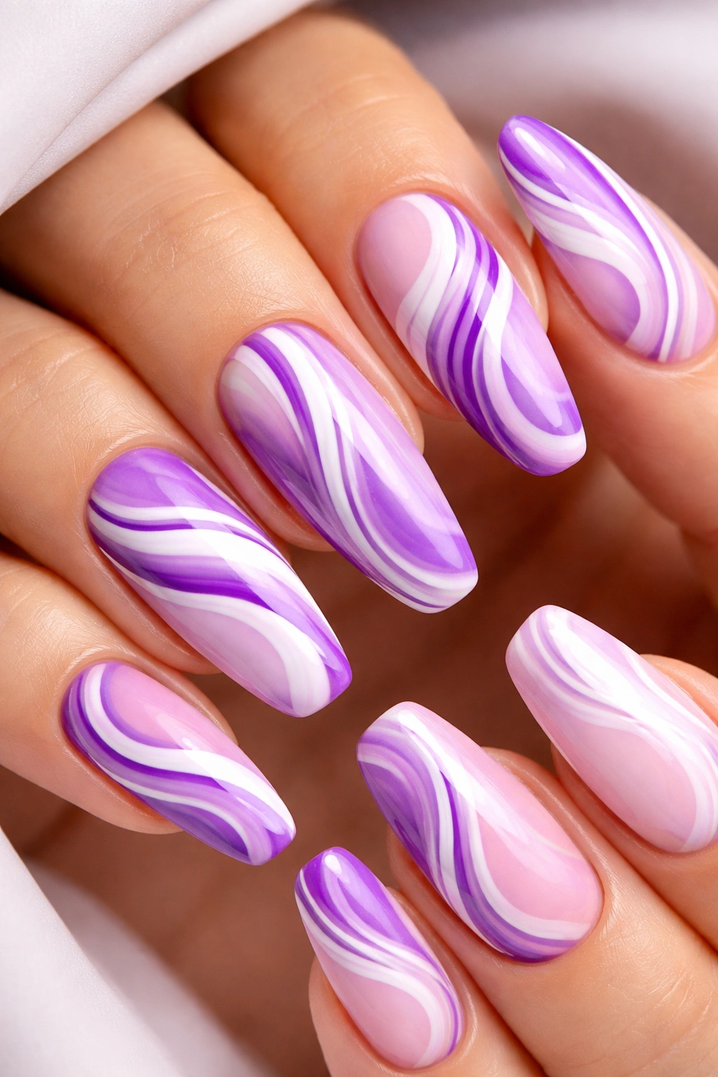 Purple and white swirl nails close-up