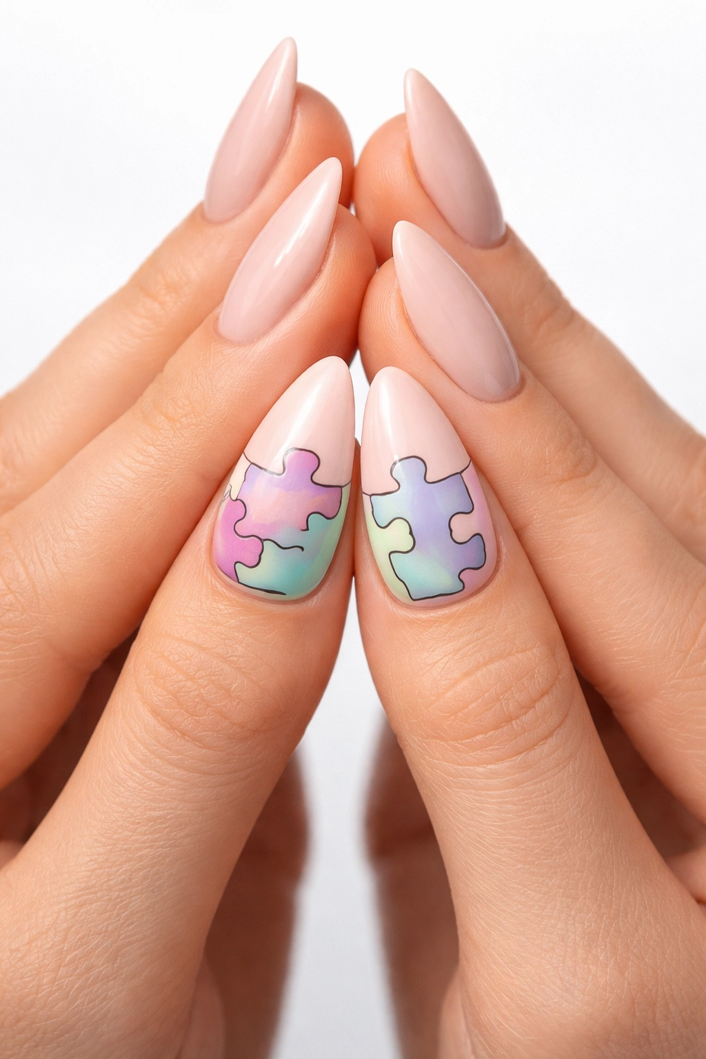 Two hands with almond nails featuring puzzle piece accents that connect when pressed together