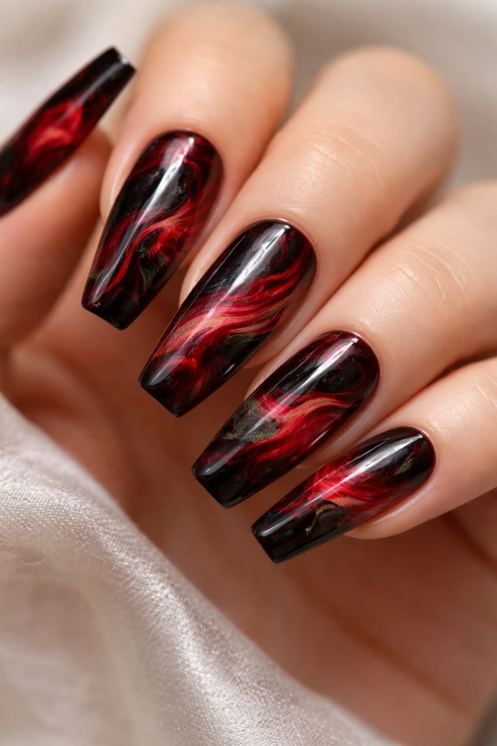Coffin nails with red and black marble pattern in a close-up shot