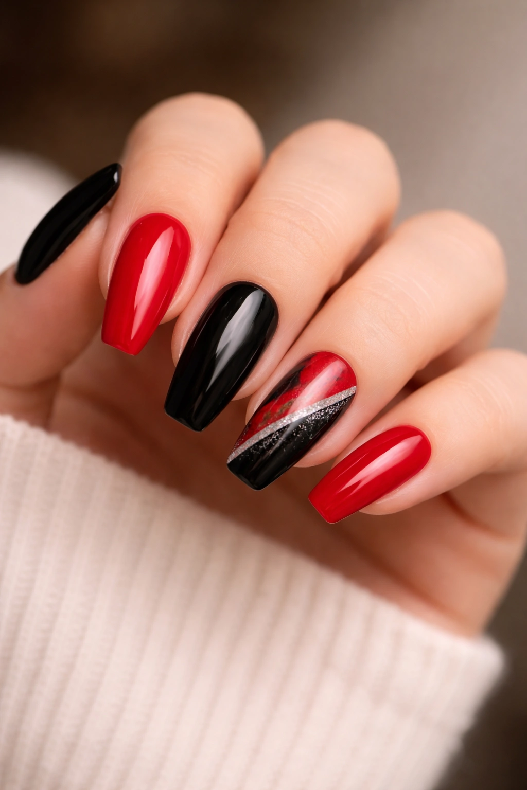 Alternating red and black nails with a diagonal split statement nail.