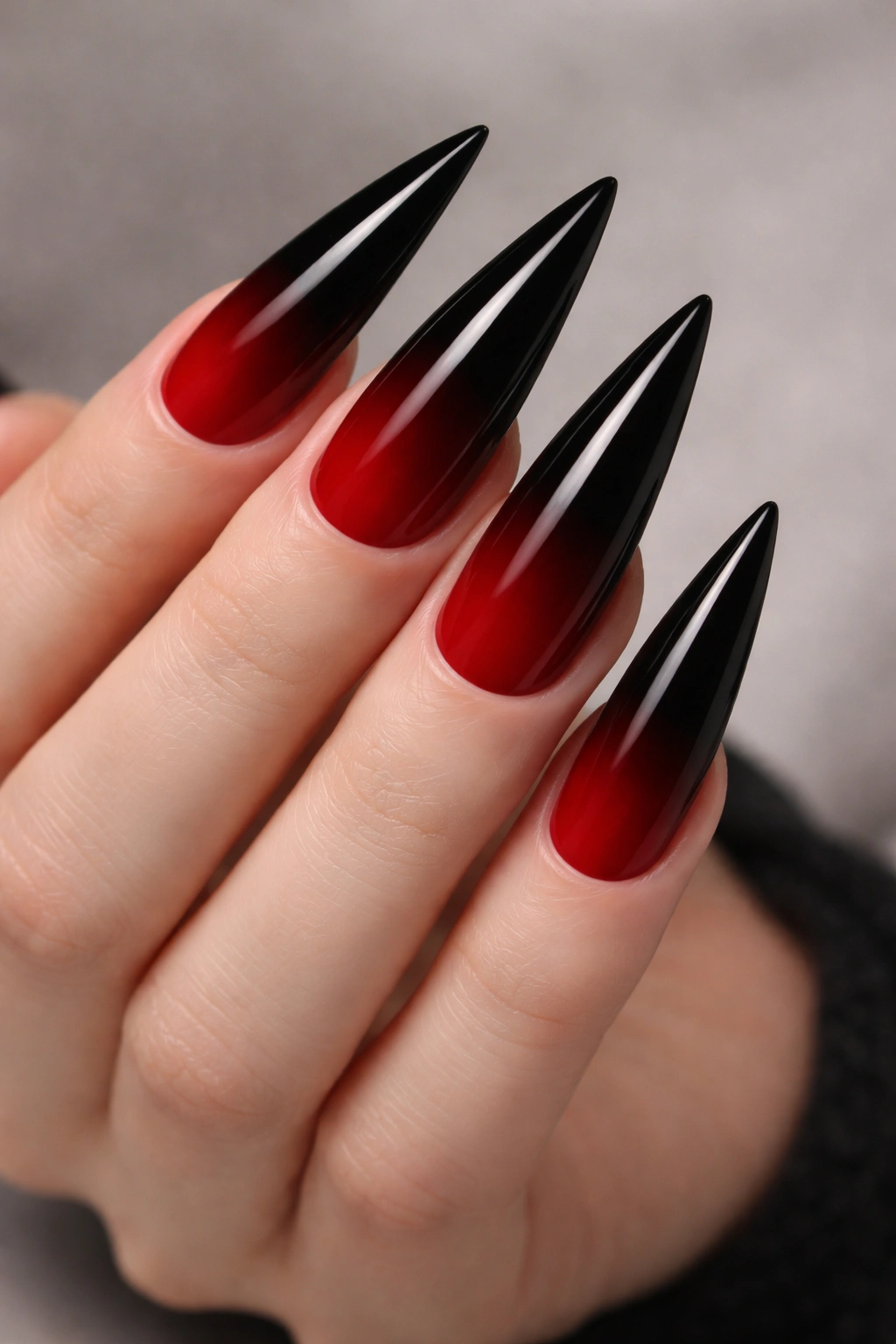 Nails with a red-to-black ombre gradient from base to tip.