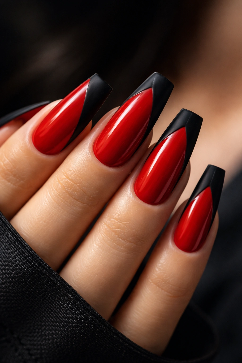 Coffin nails with a glossy red base and matte black accents