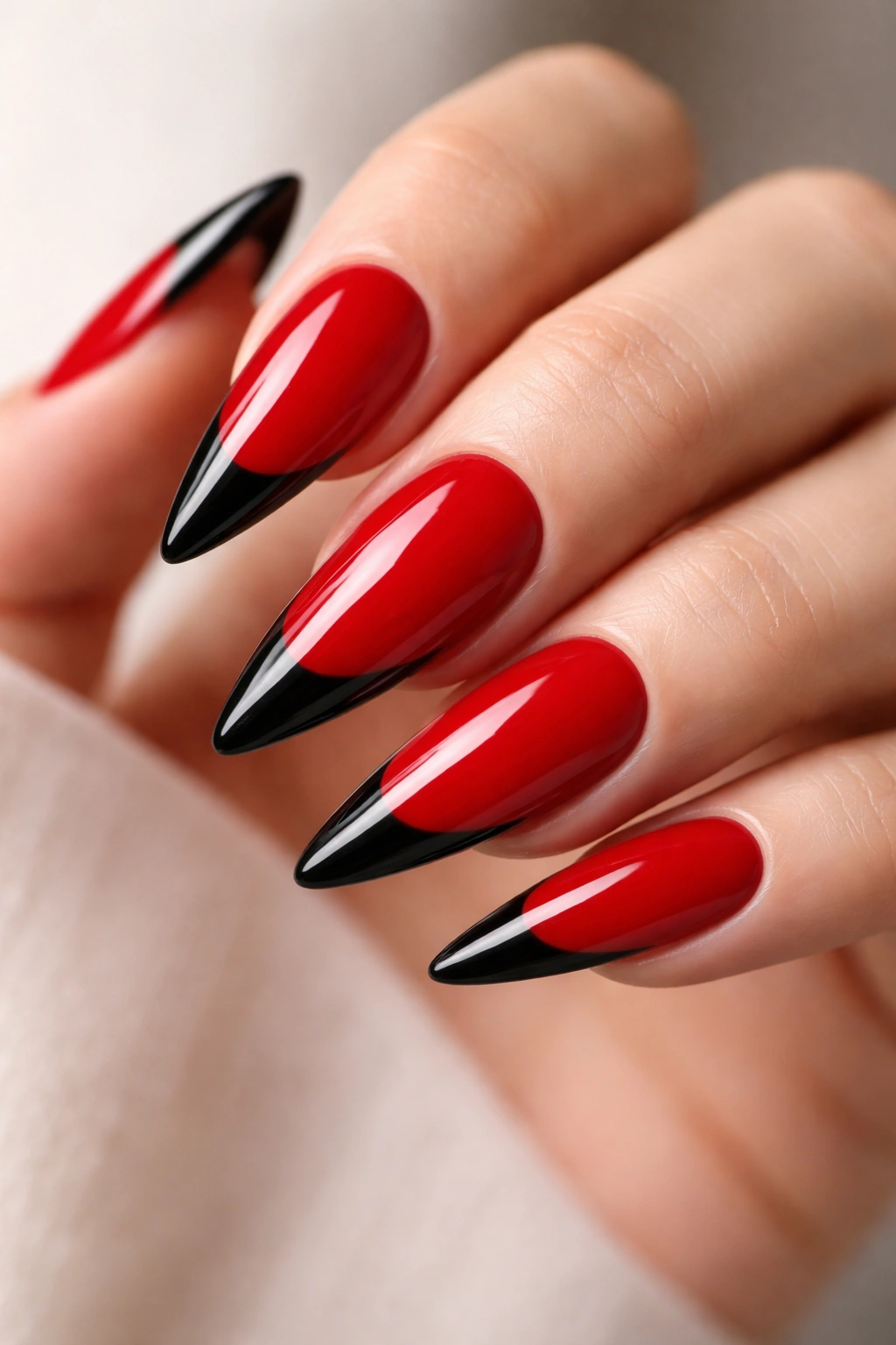 Red nails with black tip on stiletto shape