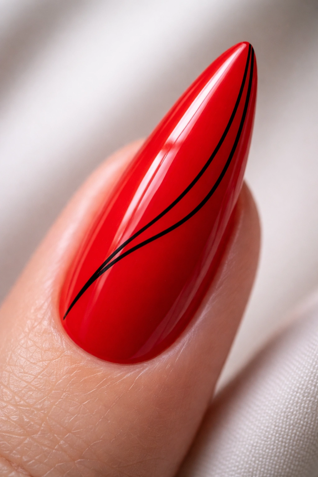 Glossy red nail with a single thin black line art.