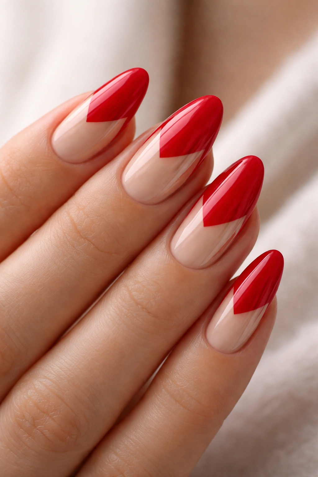 Red almond nails with nude negative-space geometric design