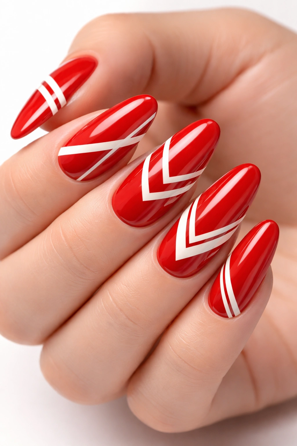 Red nails with white geometric patterns