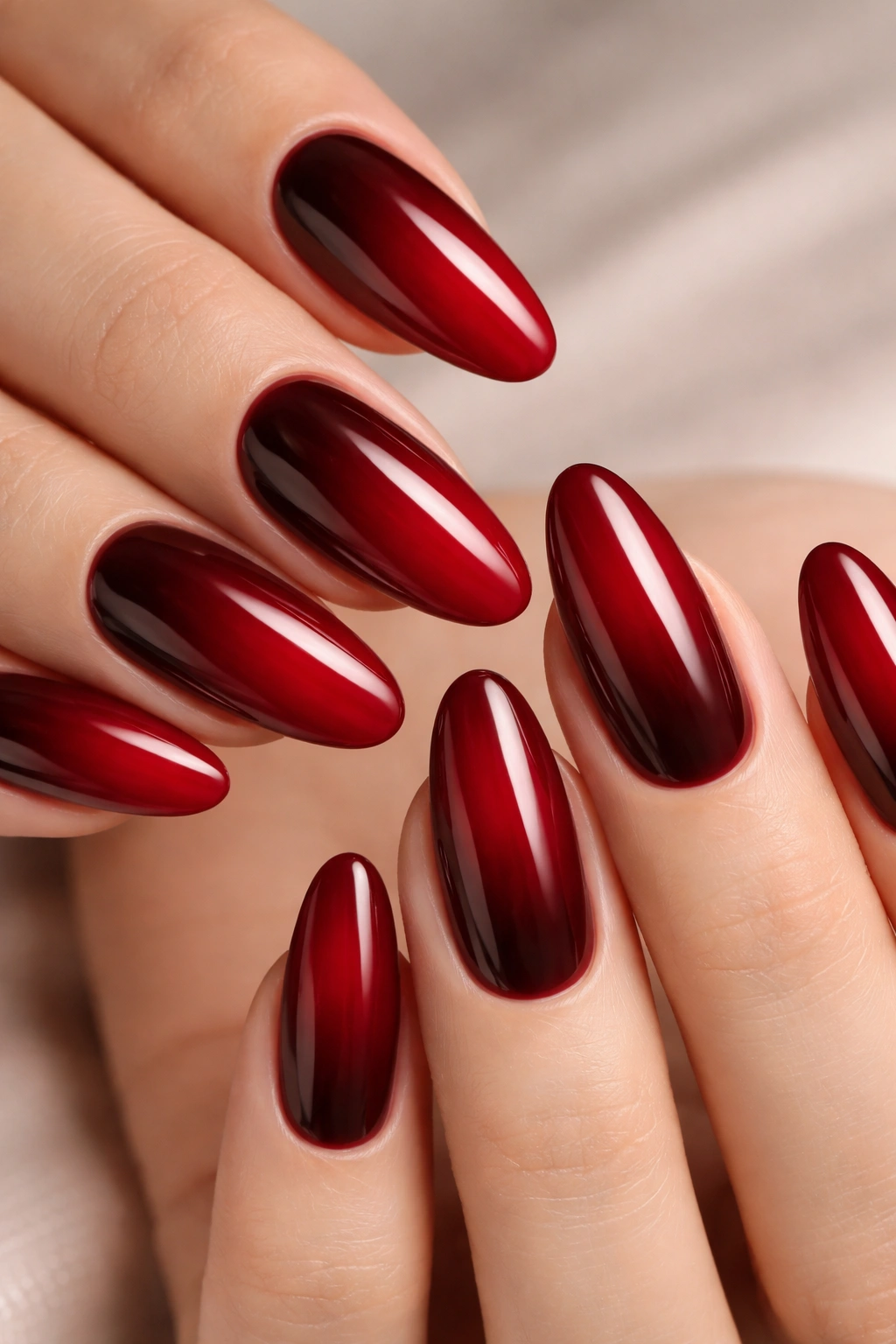 Long oval nails with deep red ombre gradient from burgundy to cherry