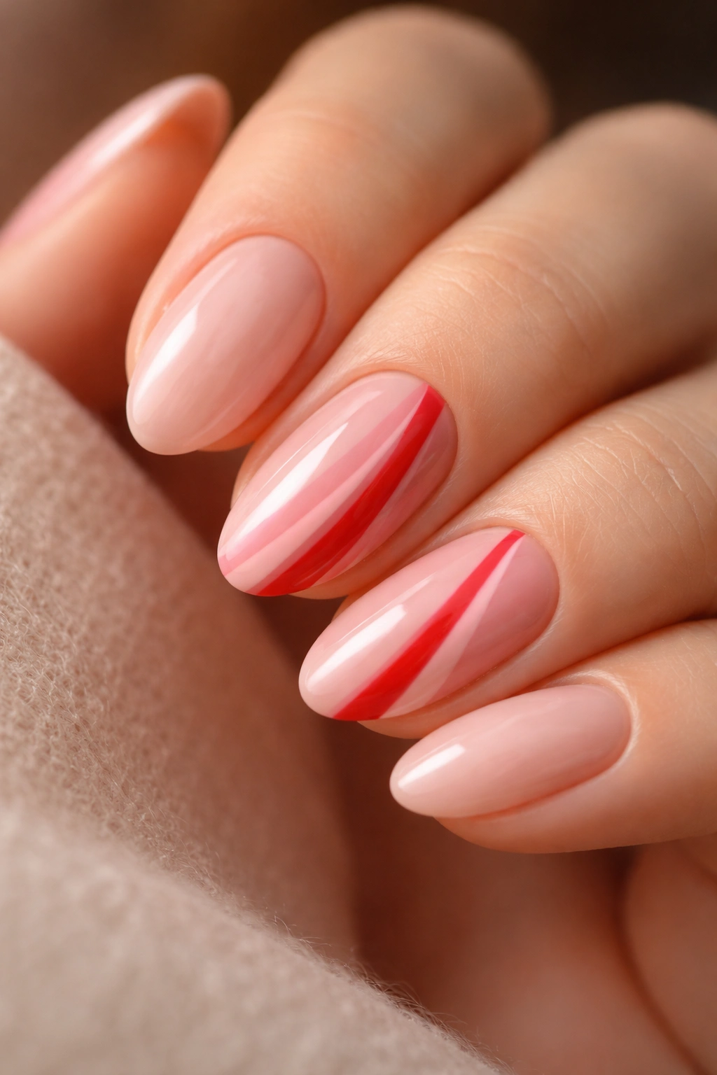 Short almond nails with red and pink skinny stripes on neutral base
