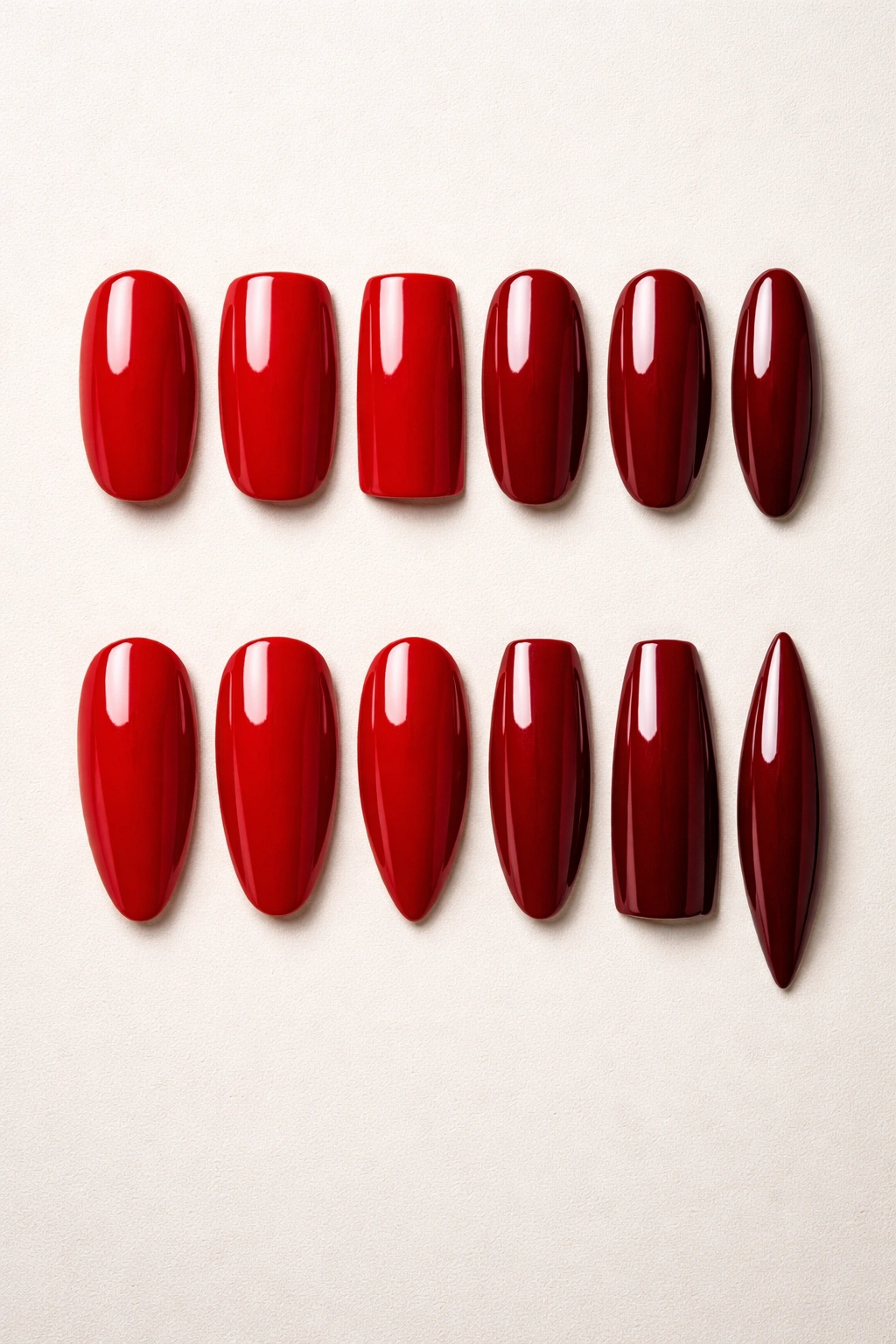 Flat lay of red nail tips in multiple shapes with different red shades
