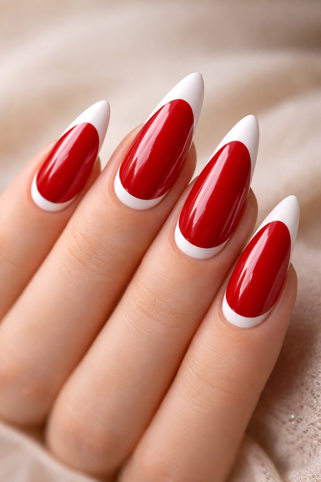 Red stiletto nails with white reverse French tips