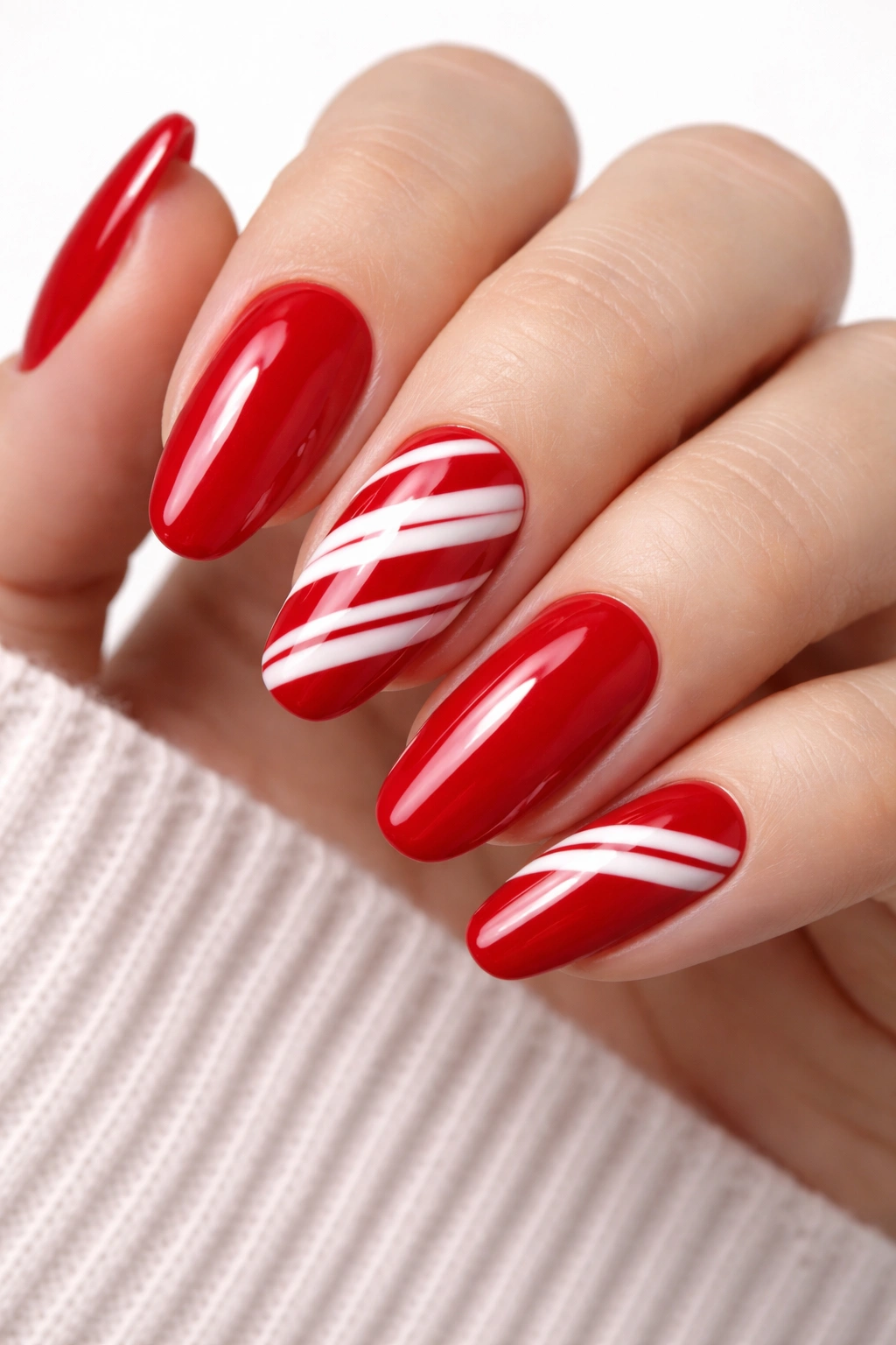 Close-up of classic red nails with white striped details on a neutral background