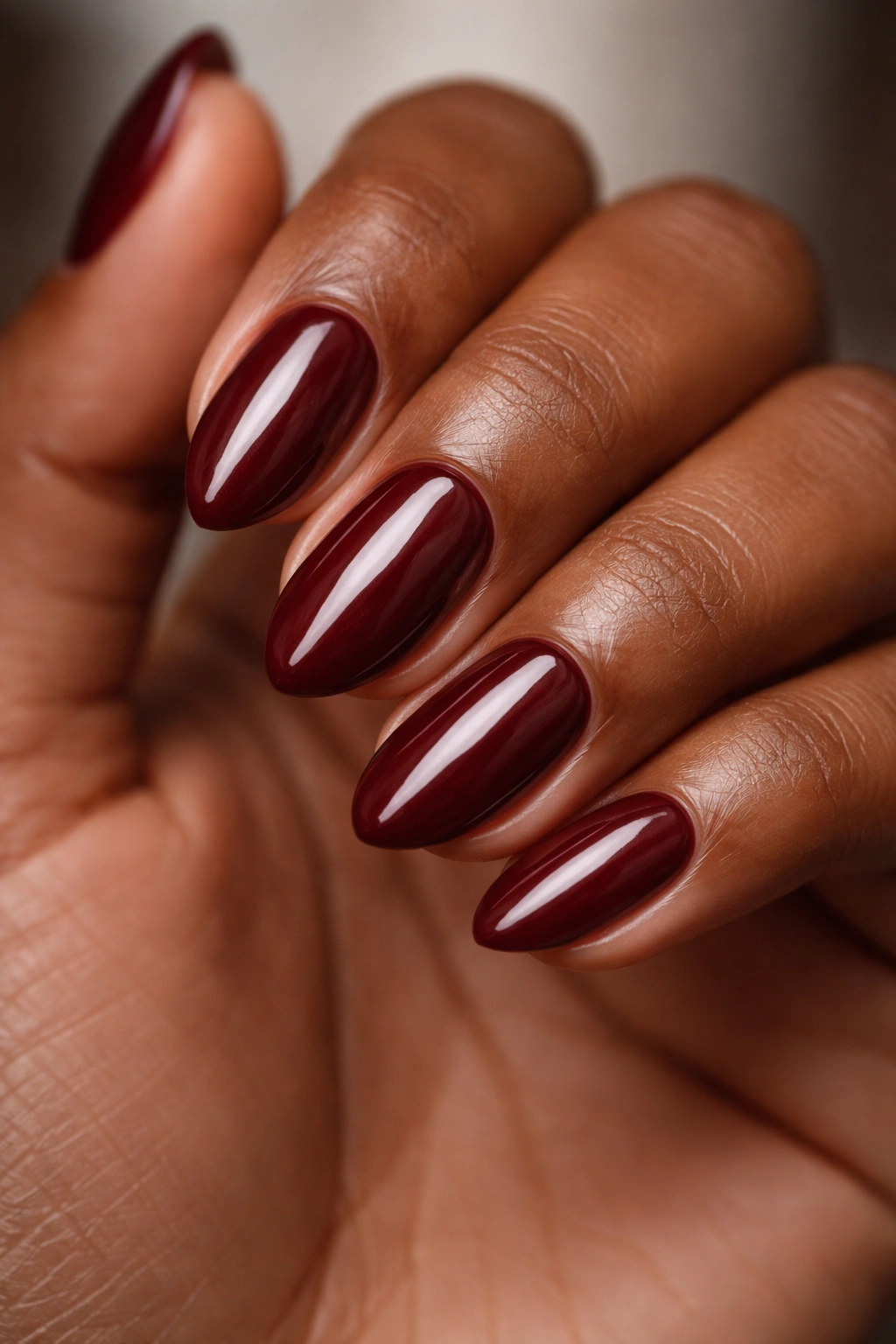 Close-up of red wine short almond nails