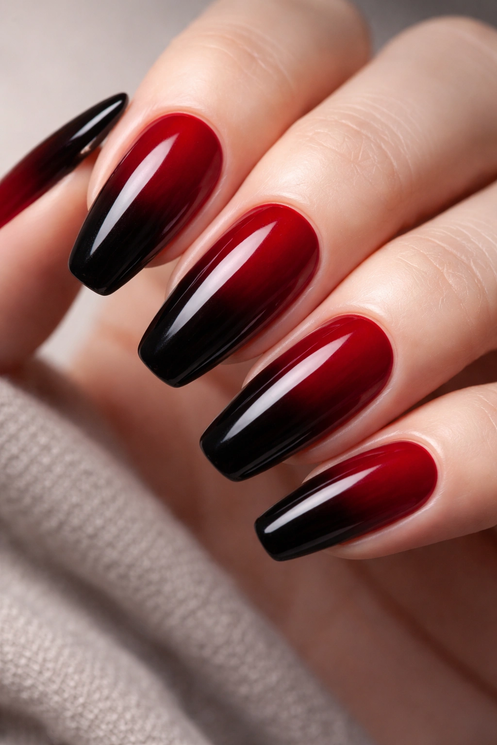 Nails with red-to-black ombre gradient close-up
